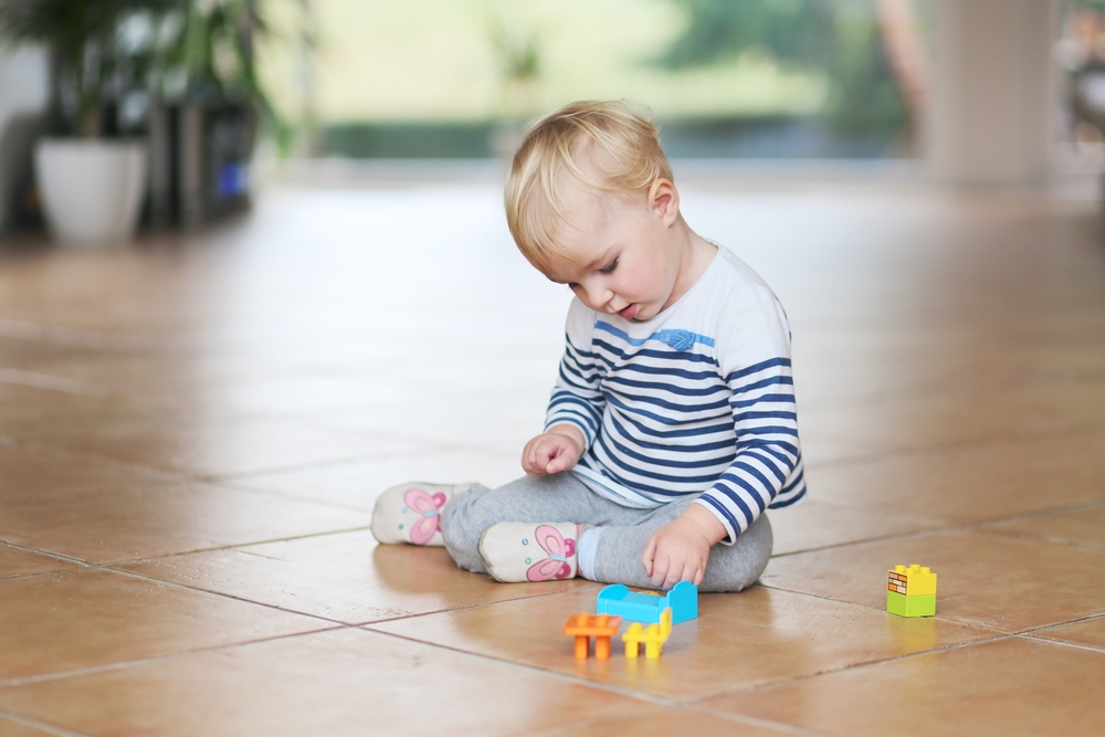 baby-playing-on-ceramic-floor